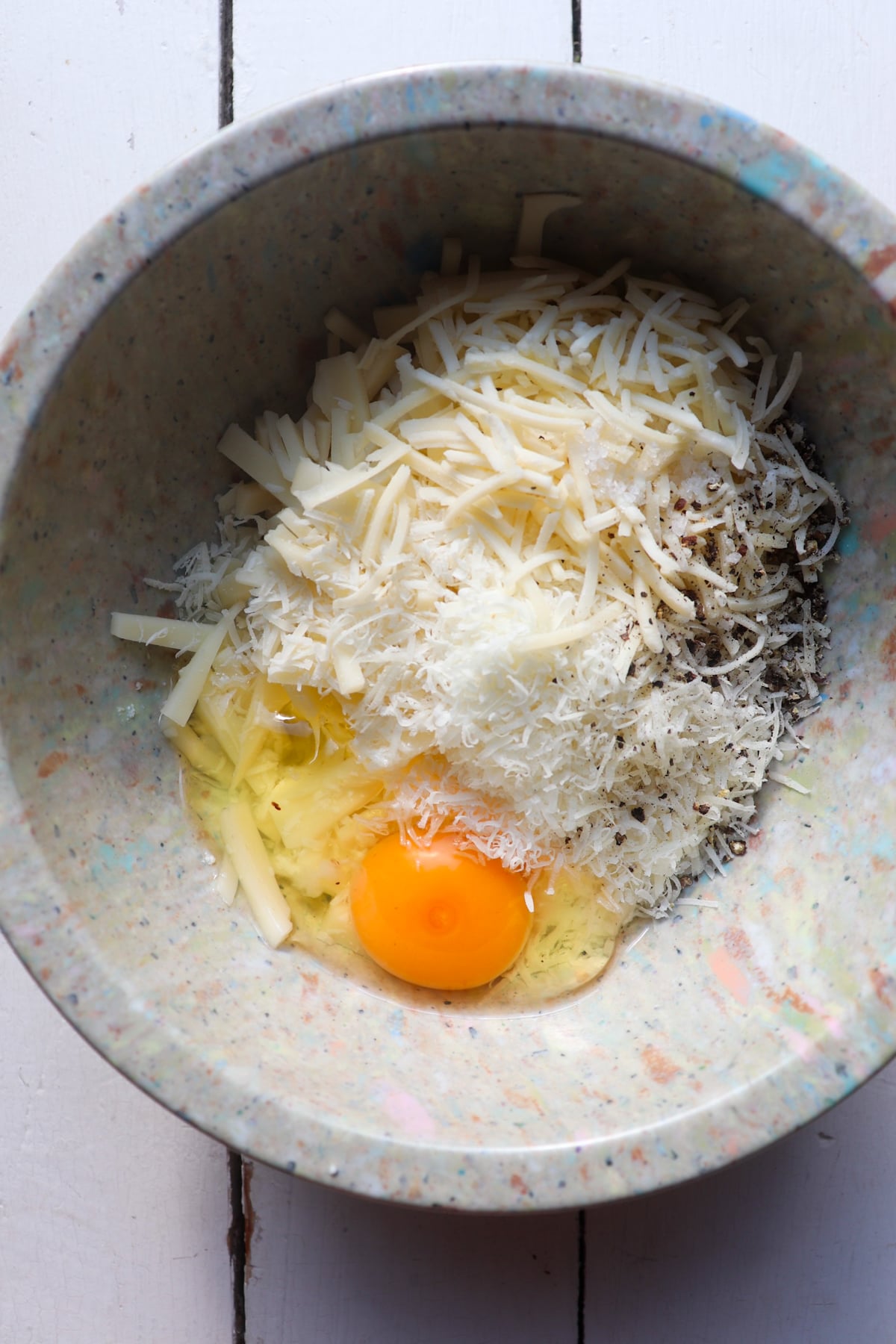 four cheese mixture in a mixing bowl but unmixed.
