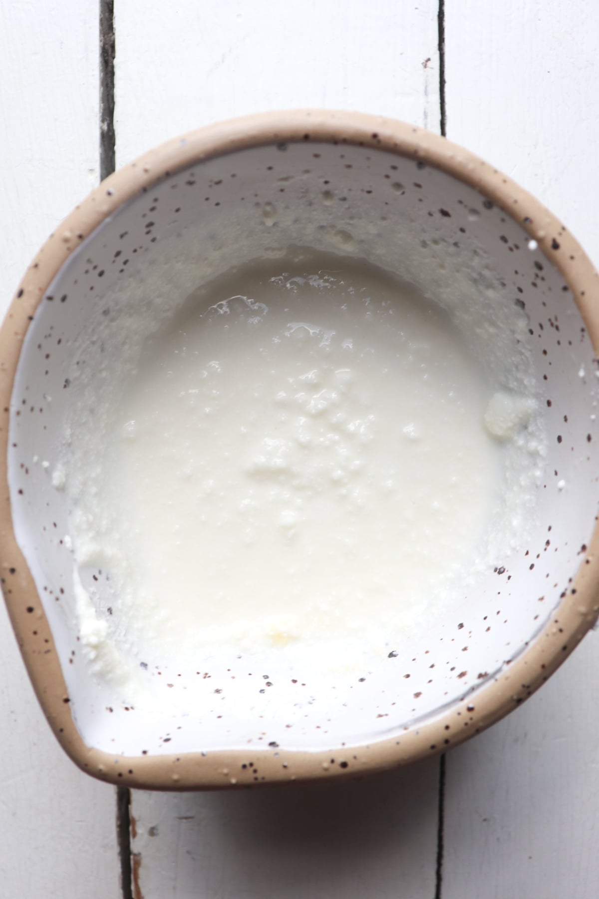 ricotta cheese garnish mixture in a small white bowl.