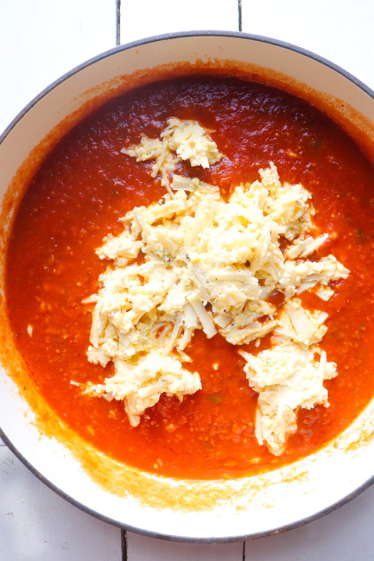 cheese mixture added to red sauce.