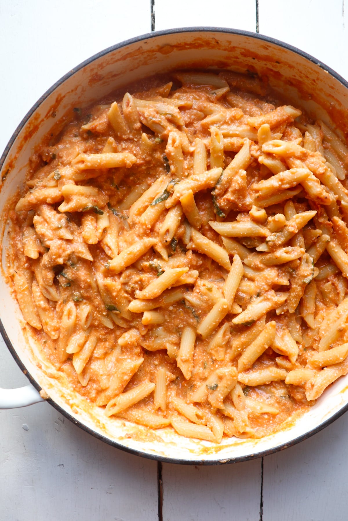 finished pasta all mixed together in a white skillet.