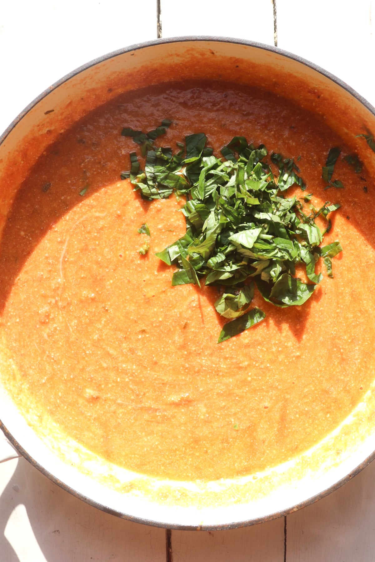 basil added to tomato cheese sauce.