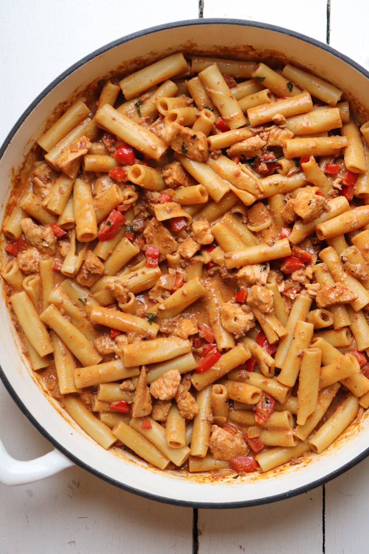 finished chicken and chorizo pasta in a white skillet.