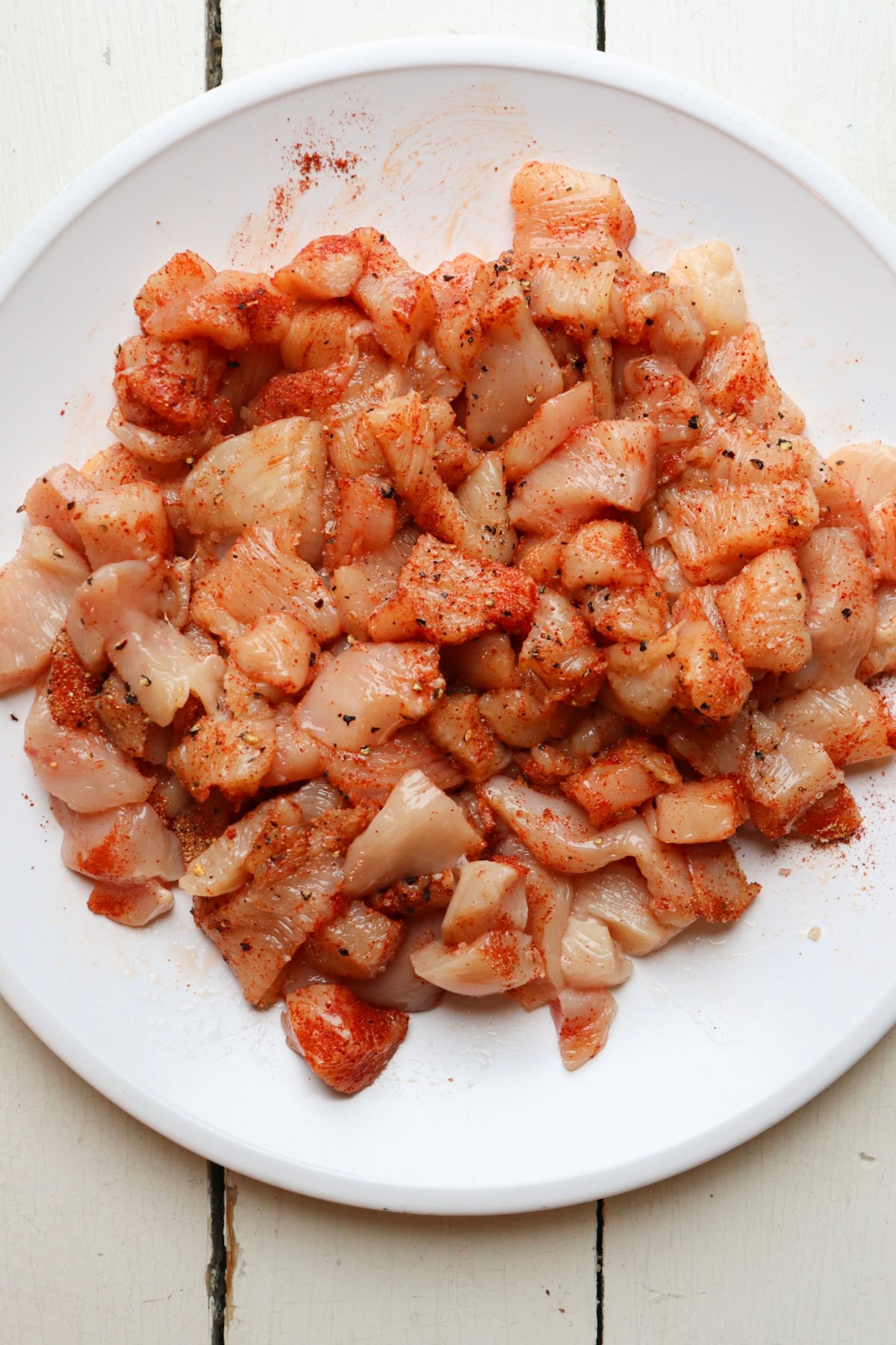 bite sized raw chicken pieces coated in spice mixture.