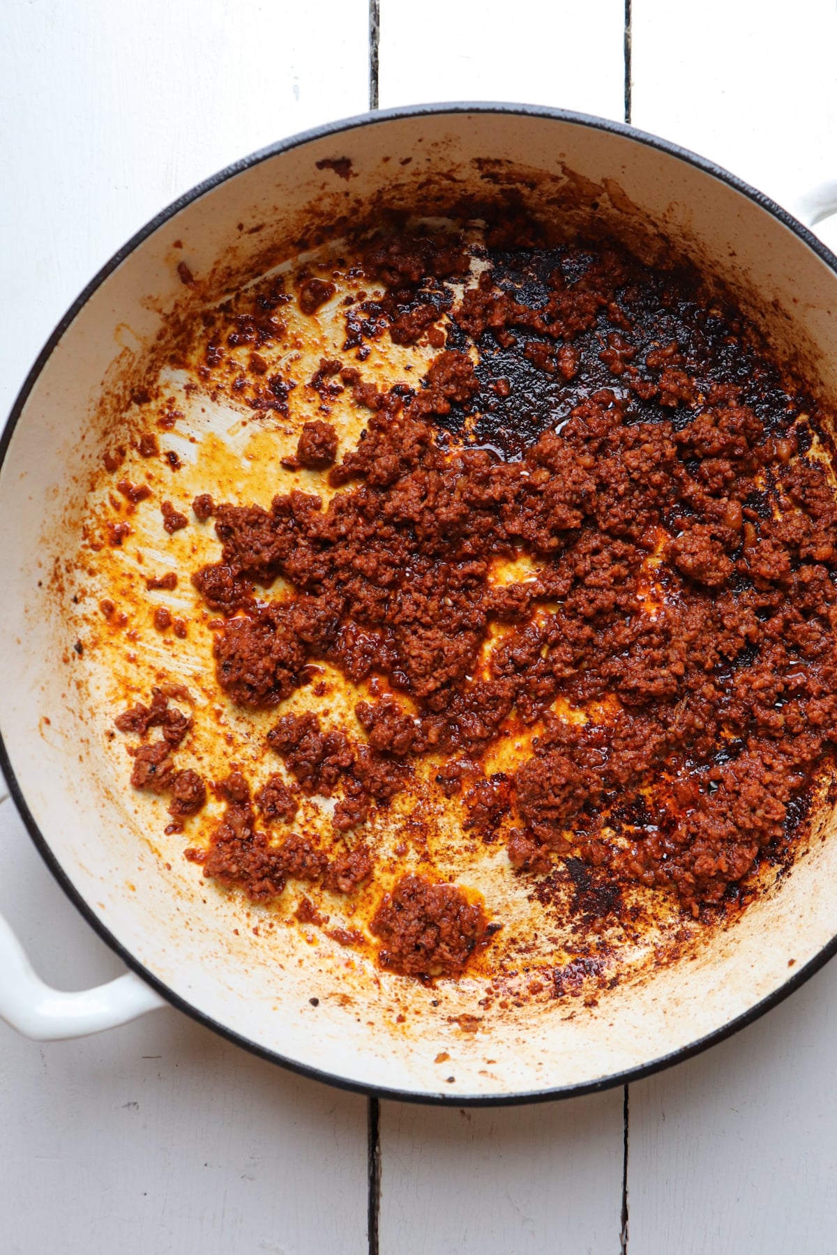 chorizo crumbles in white skillet.