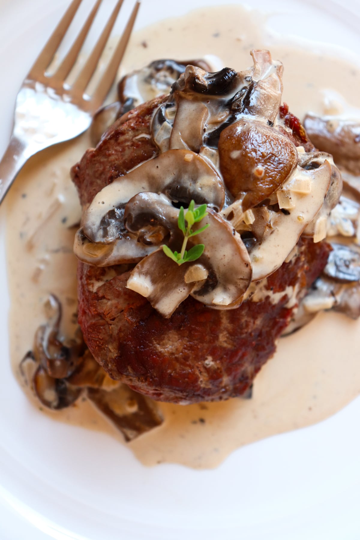 mushroom cream sauce over top of a steak.