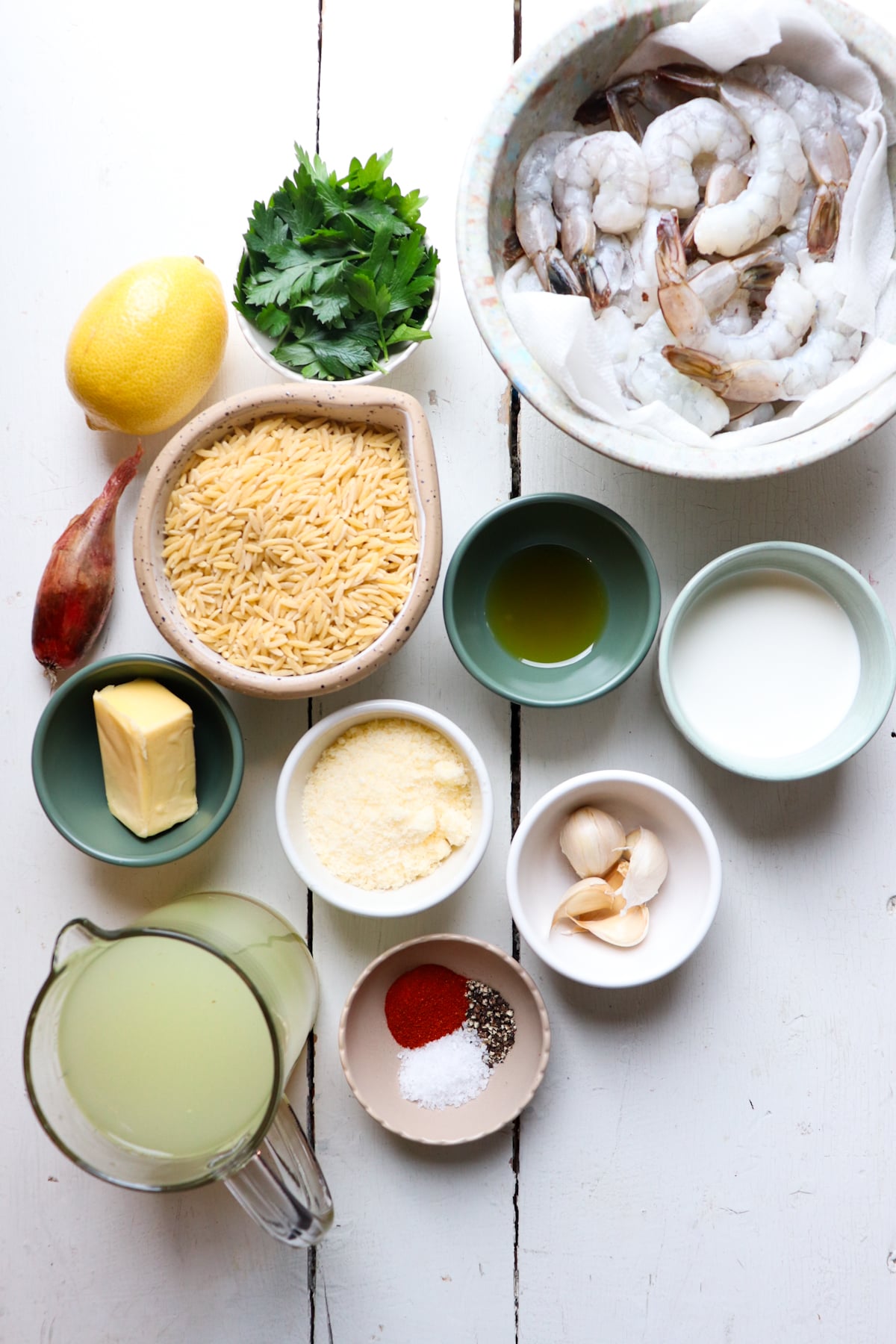 ingredients for shrimp orzo pasta on white table.