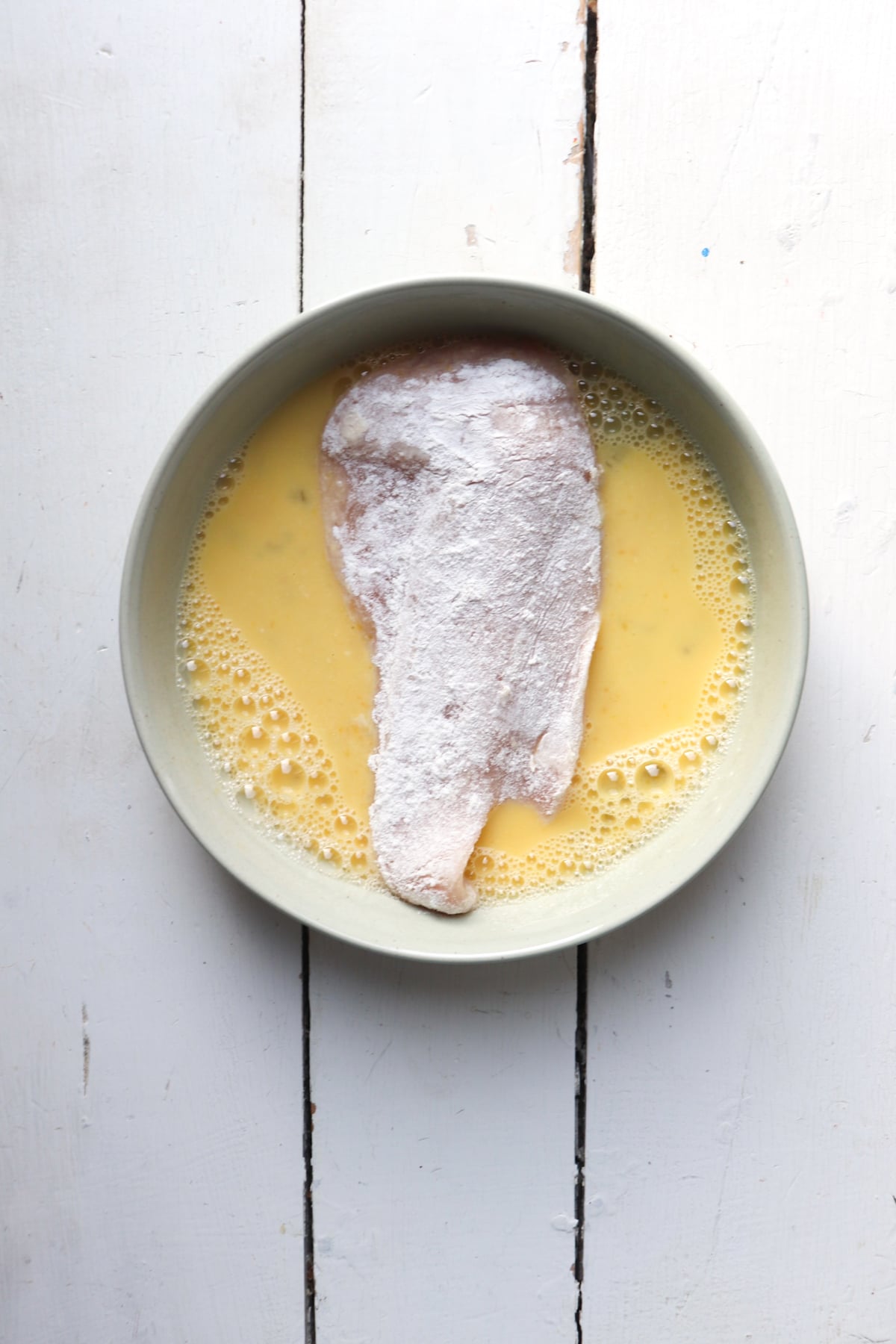 flour coated chicken breast added to egg wash.