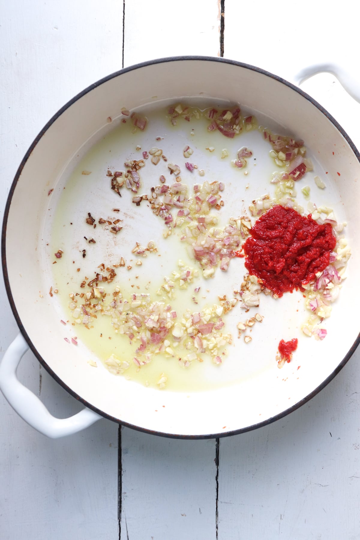 tomato paste added to aromatics in pan.