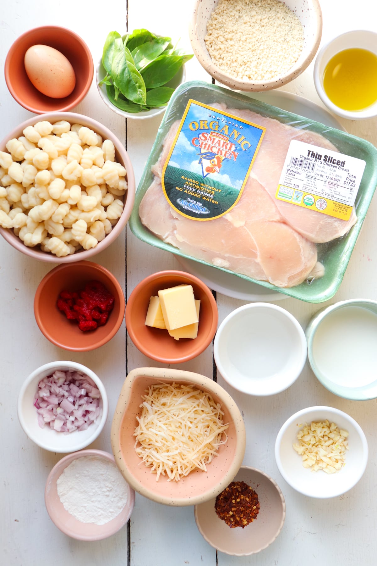ingredients for vodka gnocchi and chicken on a white table.